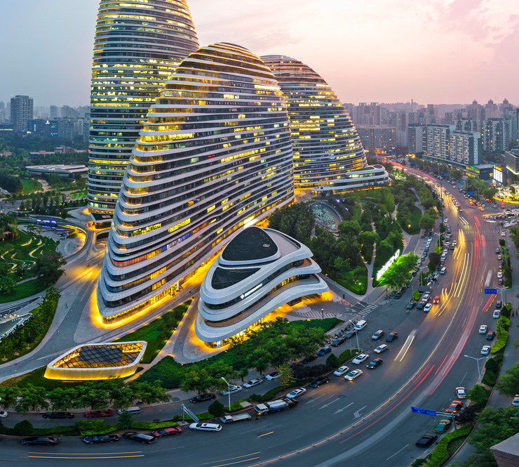 Aerial shot of three curvilinear asymmetric skyscrapers and Wangjing skyline in Beijing, China. 